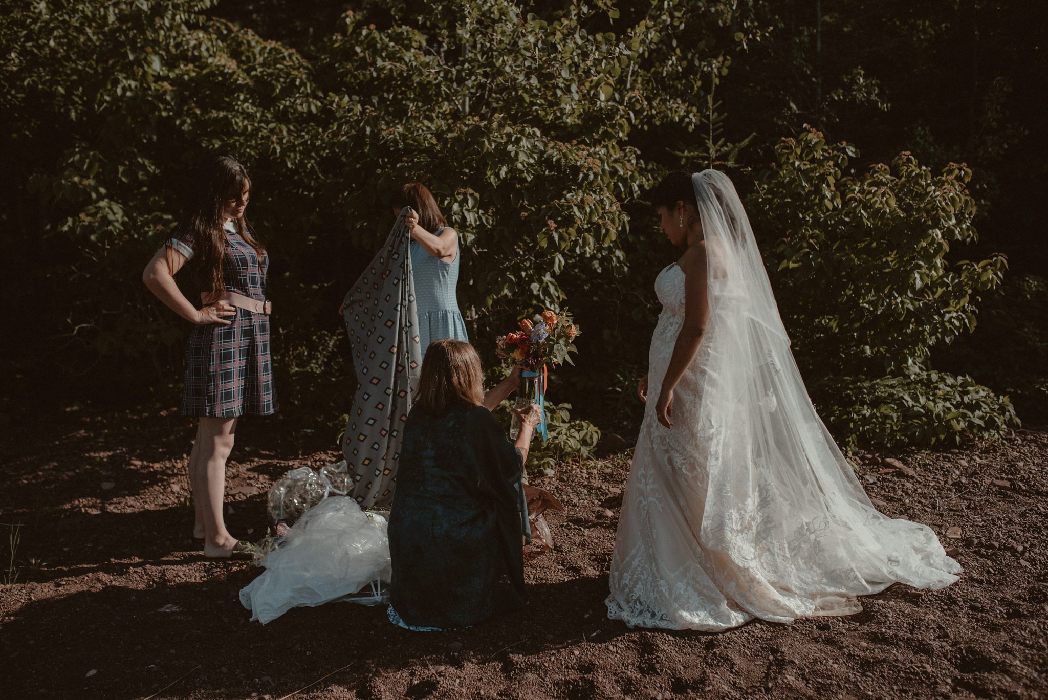 Mother offering the bride her bouquet