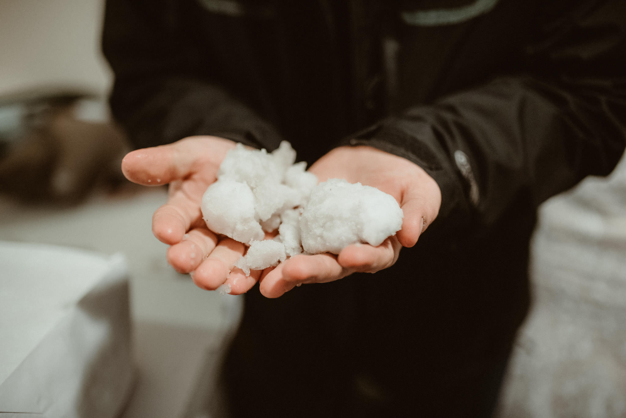 Groom holding snowballs